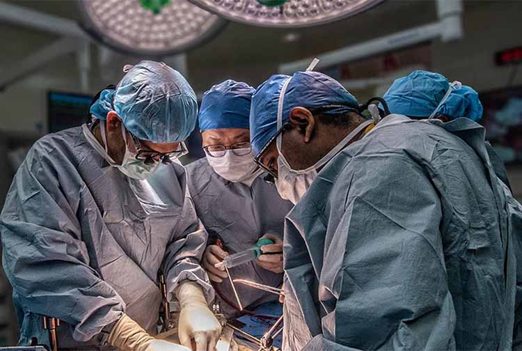 Surgeons around a patient operating on the liver