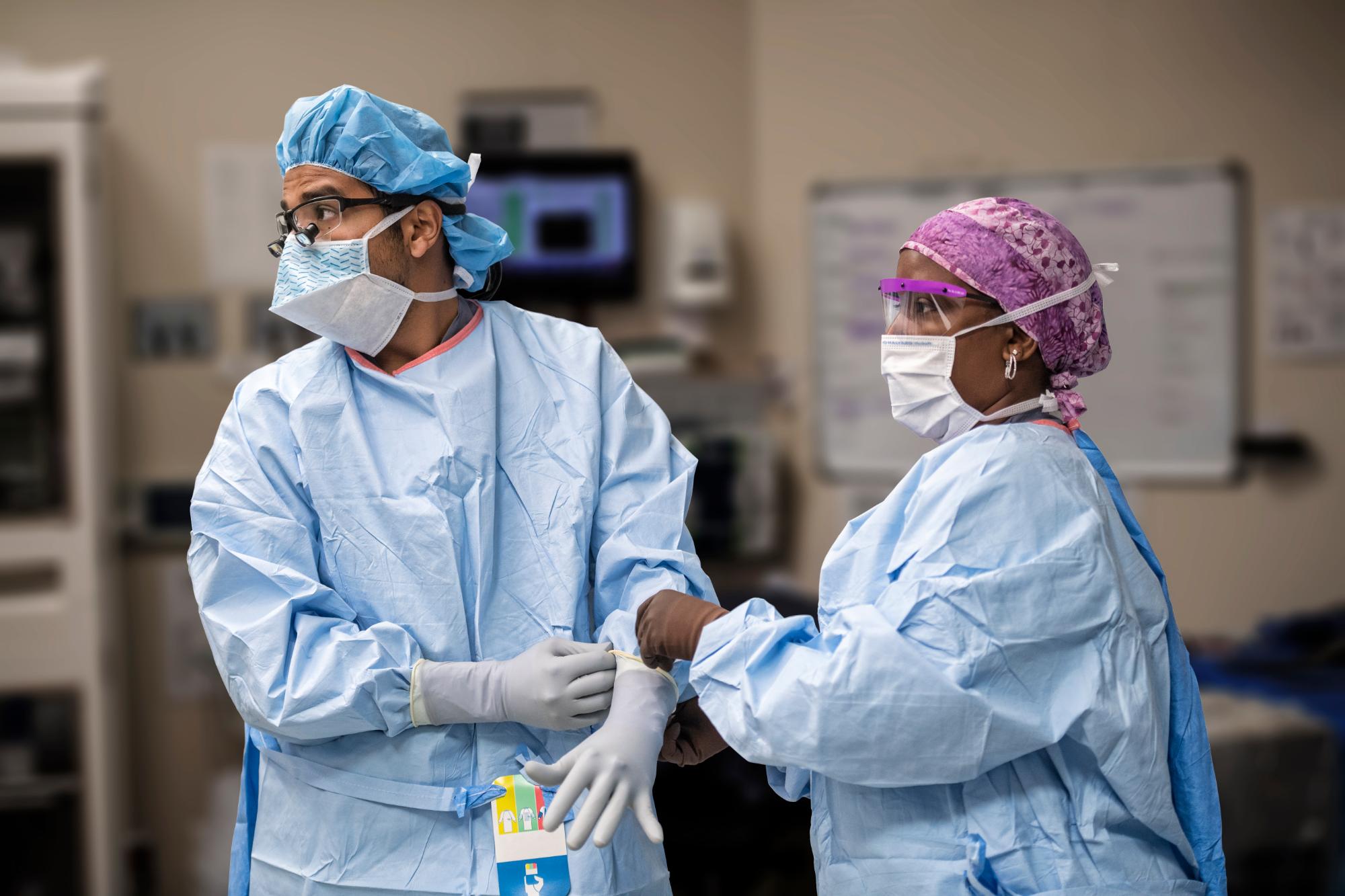 Two surgeons in scrubs preparing for surgery