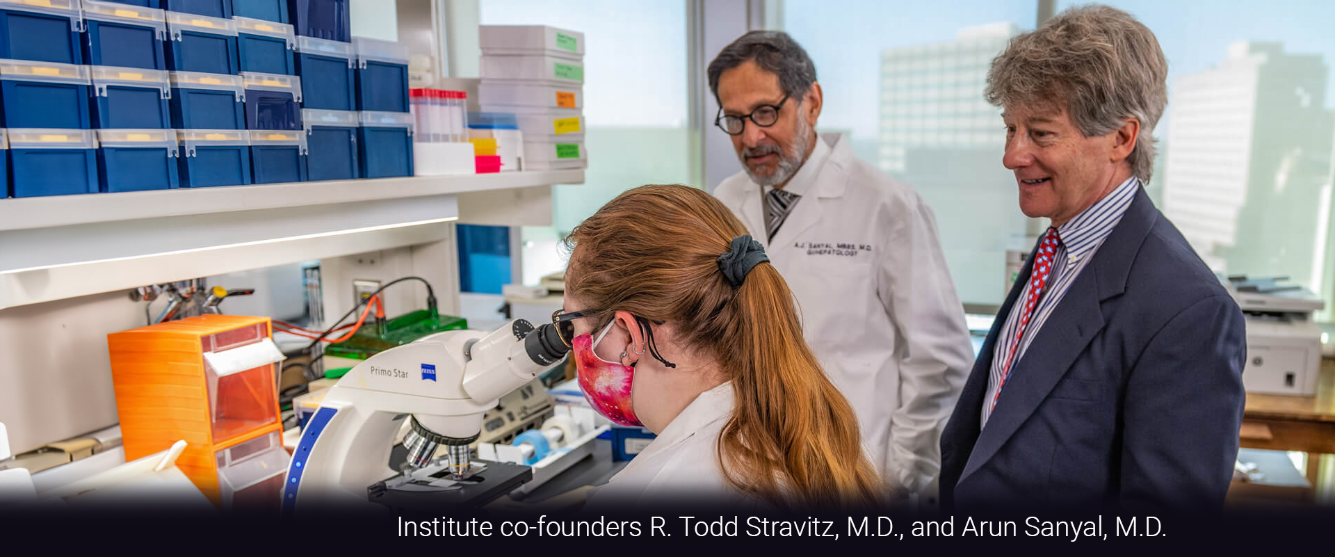 Institute co-founders R. Todd Stravitz, M.D., and Arun Sanyal, M.D. with a researcher